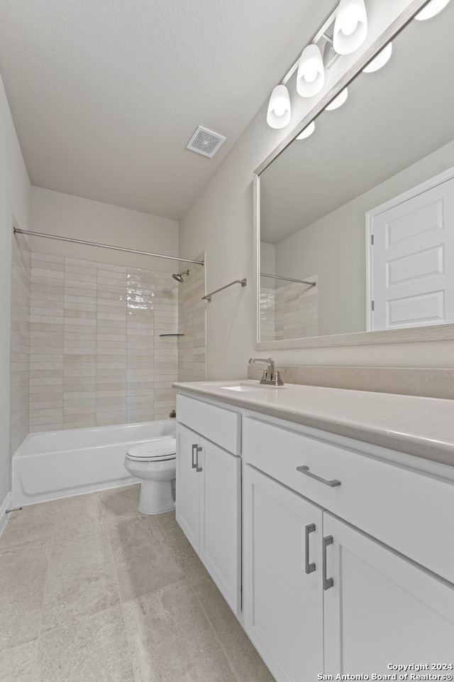 bathroom featuring a textured ceiling, vanity, and toilet