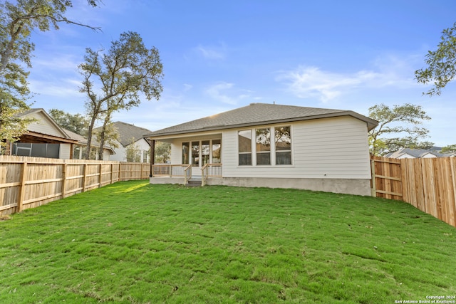 rear view of house with a lawn