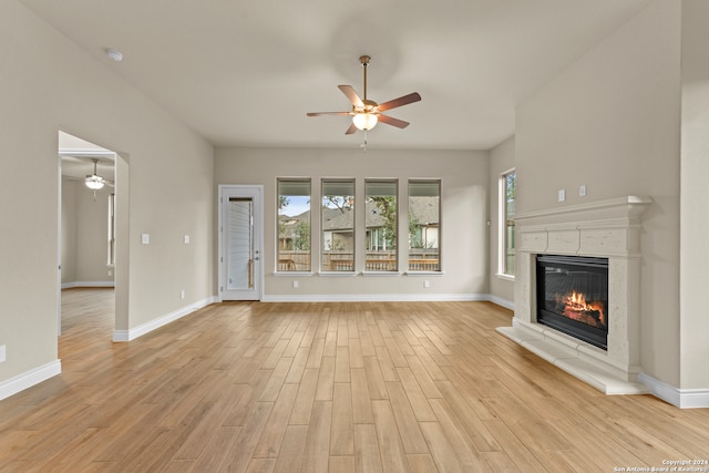 unfurnished living room with ceiling fan and light hardwood / wood-style flooring