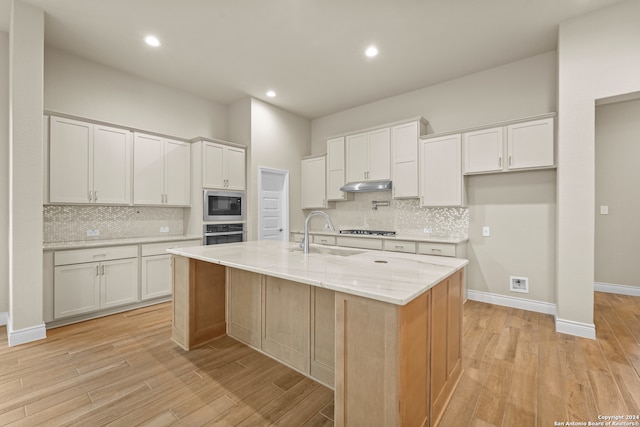 kitchen featuring white cabinets, sink, a kitchen island with sink, and stainless steel appliances