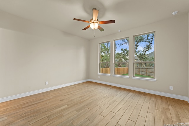 unfurnished room with light wood-type flooring and ceiling fan