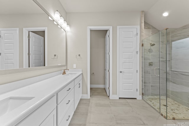 bathroom featuring tile patterned floors, a shower with door, and vanity