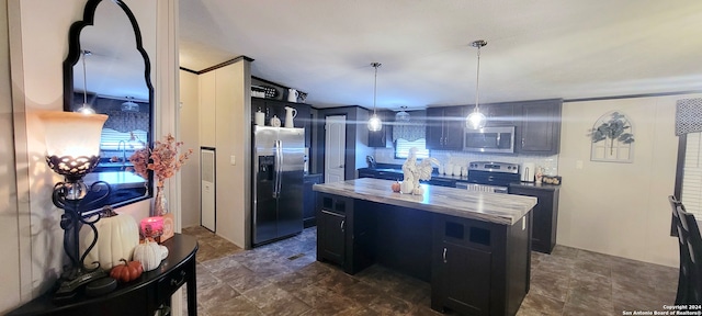 kitchen with decorative light fixtures, appliances with stainless steel finishes, and a center island