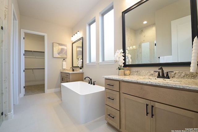 bathroom featuring vanity and independent shower and bath