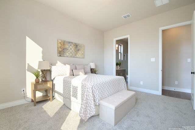 carpeted bedroom featuring ensuite bathroom