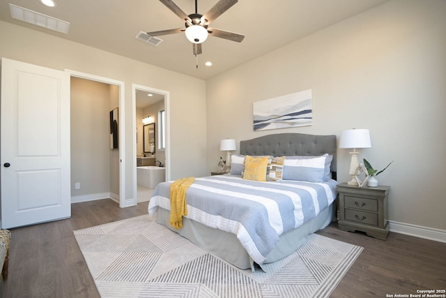 bedroom with ensuite bathroom, dark wood-type flooring, and ceiling fan