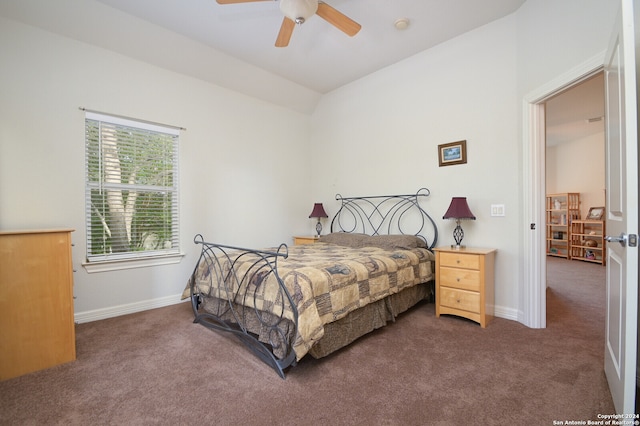 bedroom featuring lofted ceiling, dark colored carpet, and ceiling fan