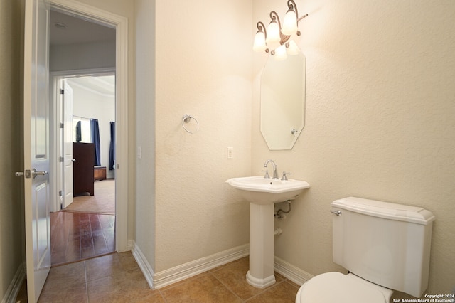 bathroom featuring toilet and tile patterned floors