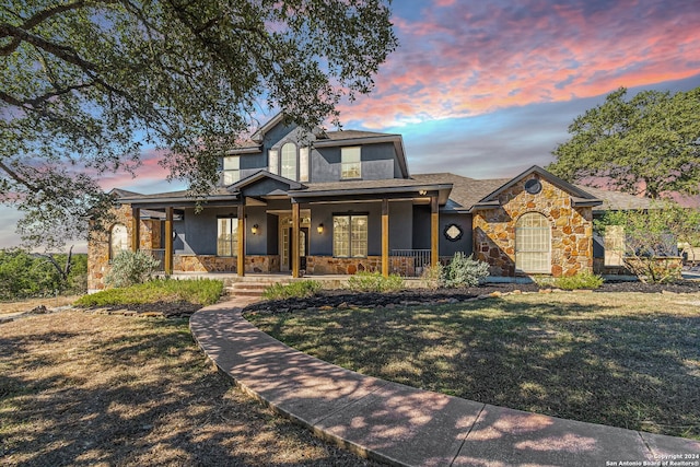 view of front of property with a lawn and a porch