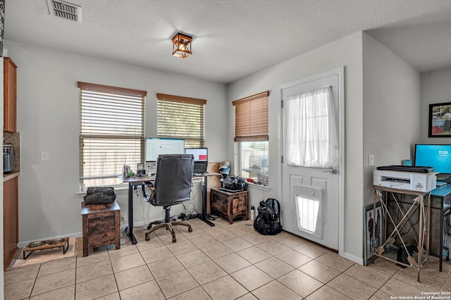 office space featuring a textured ceiling and light tile patterned floors