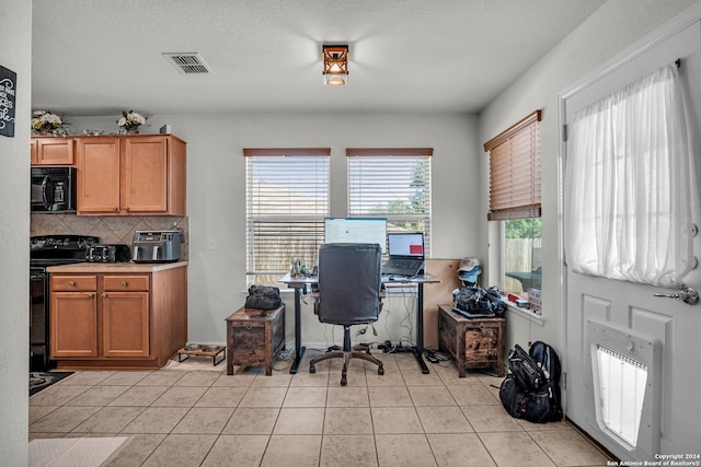 tiled home office featuring a textured ceiling