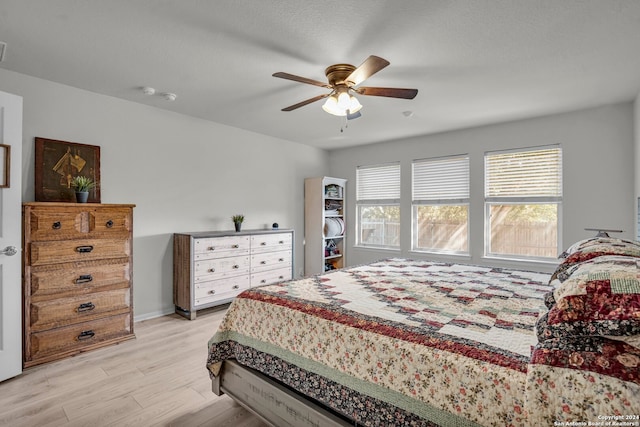 bedroom with light hardwood / wood-style floors and ceiling fan