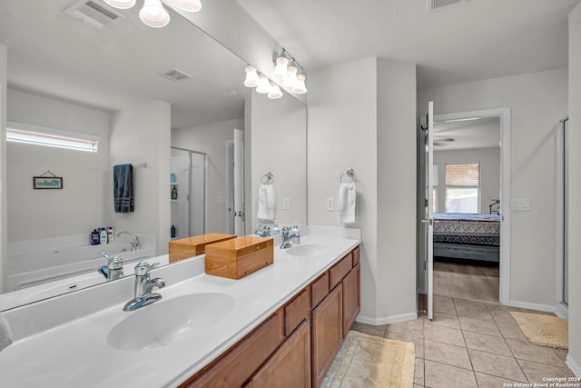 bathroom with tile patterned flooring, vanity, and plus walk in shower