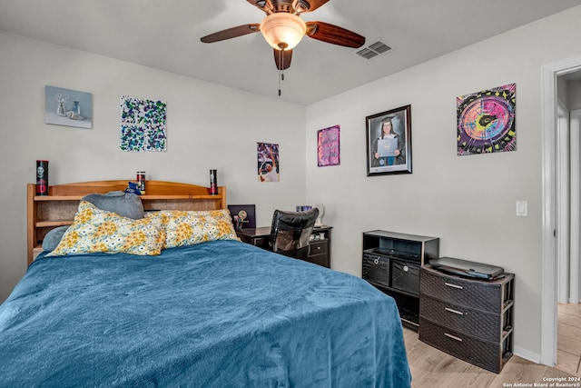 bedroom with light hardwood / wood-style floors and ceiling fan