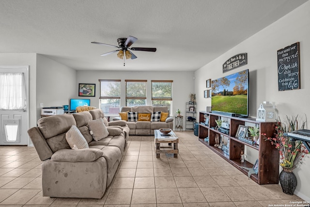 tiled living room with a textured ceiling and ceiling fan