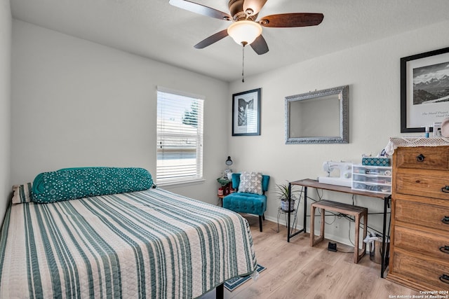 bedroom with light hardwood / wood-style flooring and ceiling fan