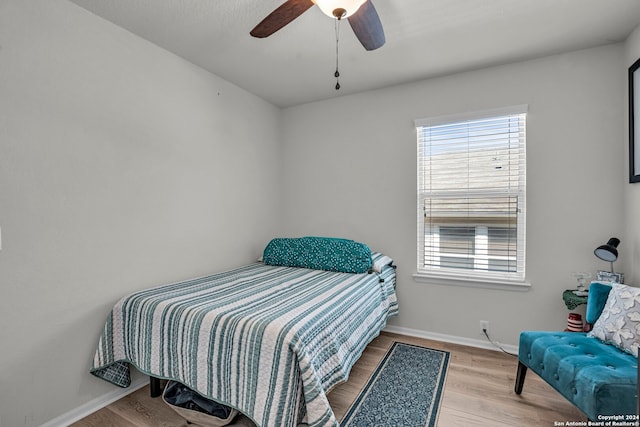 bedroom with light hardwood / wood-style flooring and ceiling fan