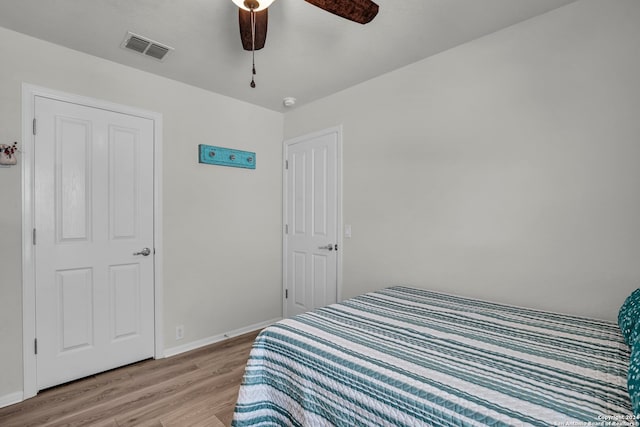 bedroom with light hardwood / wood-style floors and ceiling fan