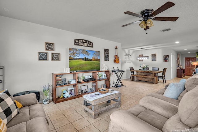 living room featuring light tile patterned floors and ceiling fan