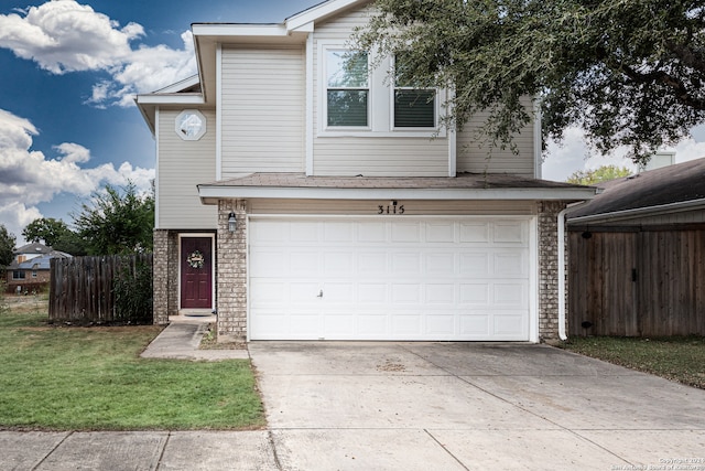 front of property featuring a front yard and a garage