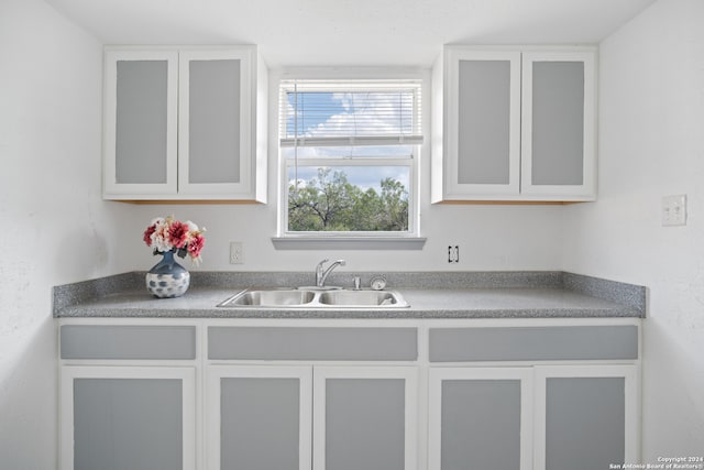 kitchen featuring sink and white cabinetry