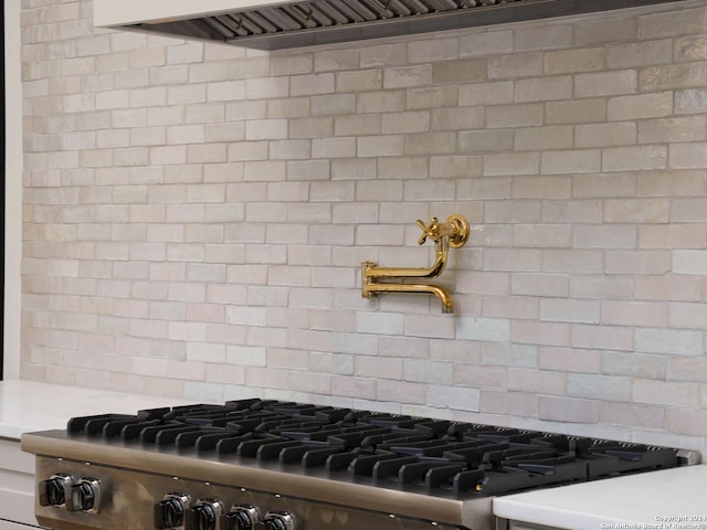 kitchen with stainless steel range and decorative backsplash