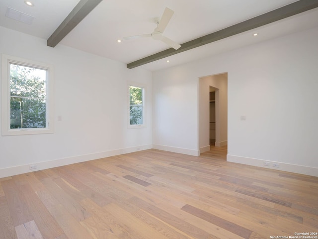 unfurnished room featuring light hardwood / wood-style flooring, beamed ceiling, and ceiling fan