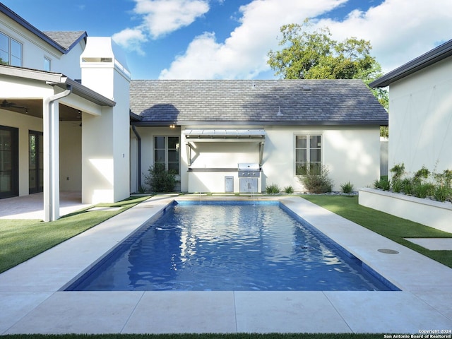 view of swimming pool with a patio area and a lawn