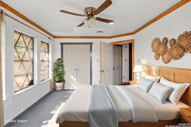 bedroom with crown molding, ceiling fan, and a textured ceiling