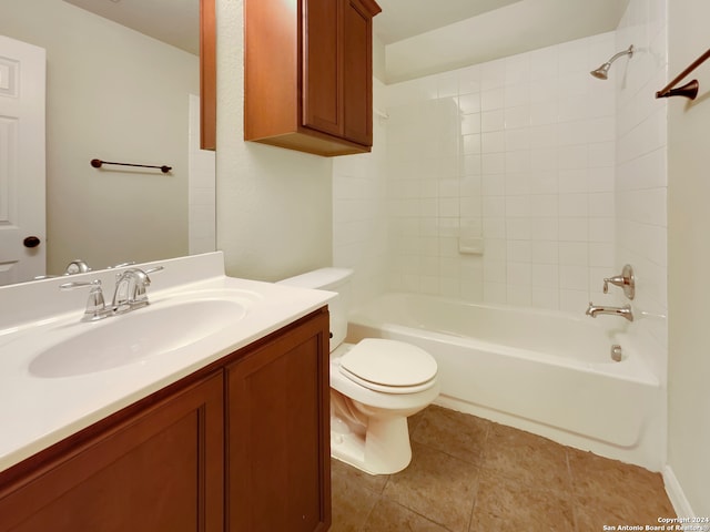 full bathroom with tiled shower / bath combo, tile patterned floors, vanity, and toilet