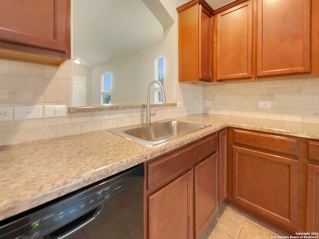 kitchen featuring light tile patterned flooring, tasteful backsplash, sink, and dishwasher