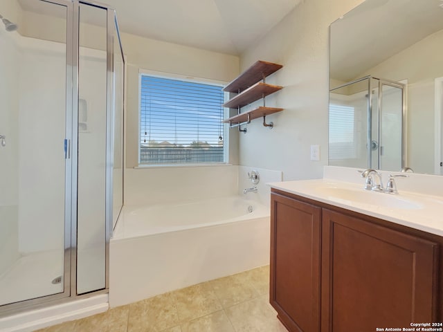 bathroom featuring vanity, plus walk in shower, and tile patterned flooring