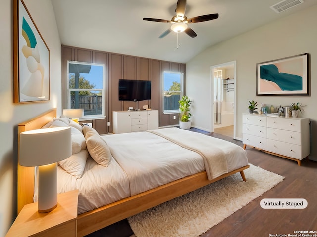 bedroom featuring ceiling fan, vaulted ceiling, dark hardwood / wood-style floors, and ensuite bathroom