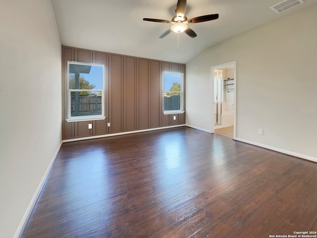 unfurnished room with ceiling fan, vaulted ceiling, and dark hardwood / wood-style flooring