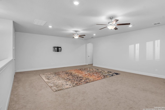 carpeted empty room featuring ceiling fan