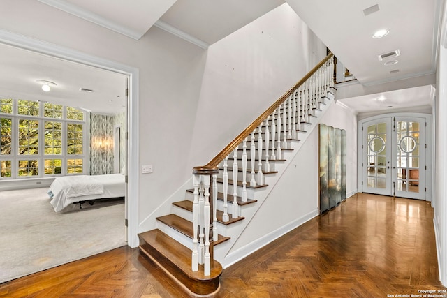 stairs with crown molding, parquet floors, and french doors