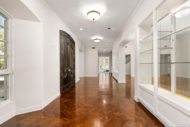 entryway featuring crown molding and dark parquet floors