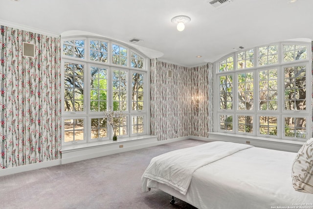 carpeted bedroom featuring ornamental molding