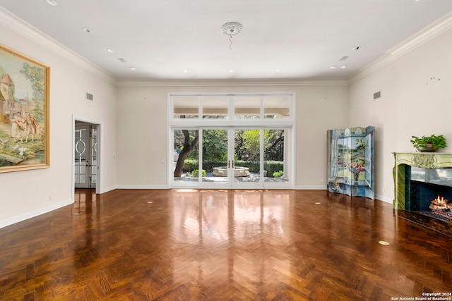 unfurnished living room with ornamental molding, dark parquet flooring, and a high end fireplace