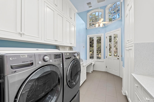 laundry room featuring cabinets and washing machine and dryer