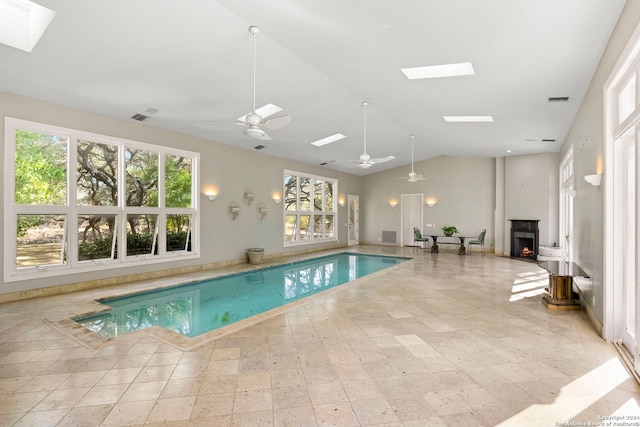 view of pool featuring a skylight and ceiling fan