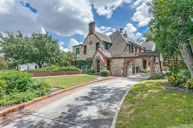 tudor home featuring a front lawn