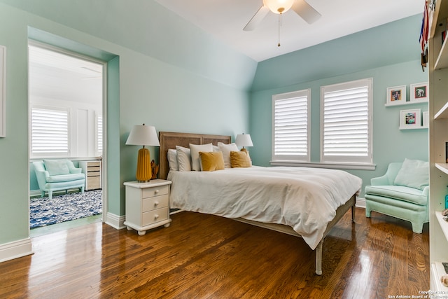 bedroom featuring dark hardwood / wood-style flooring, multiple windows, and ceiling fan