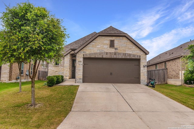 view of front facade with a garage and a front yard