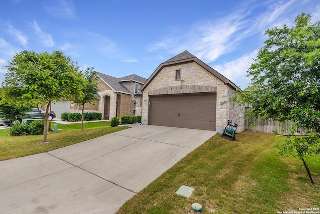 view of front of home with a front yard and a garage