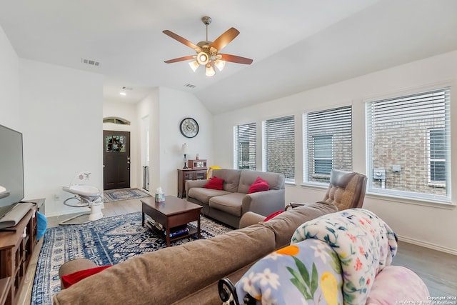 living room featuring ceiling fan, lofted ceiling, and hardwood / wood-style flooring