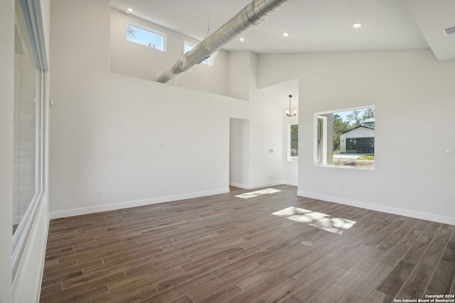 interior space with dark hardwood / wood-style floors and high vaulted ceiling