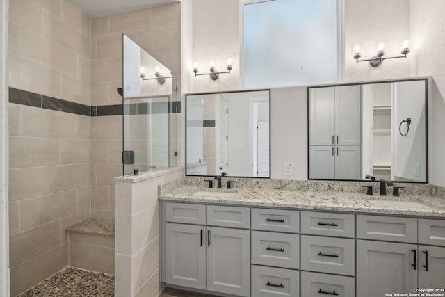 bathroom with vanity and tiled shower