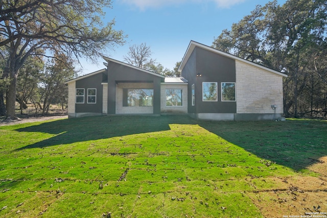 back of property featuring a yard