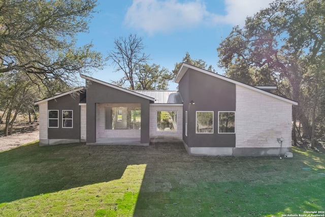 rear view of house with a yard